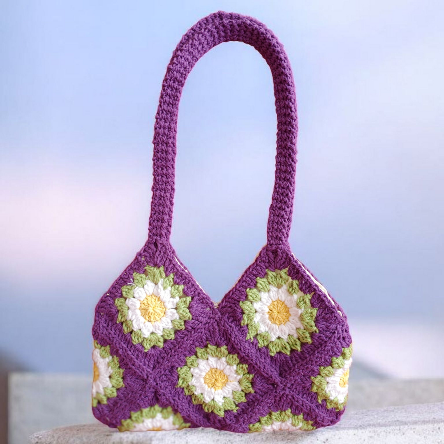Purple crochet daisy floral handbag.
