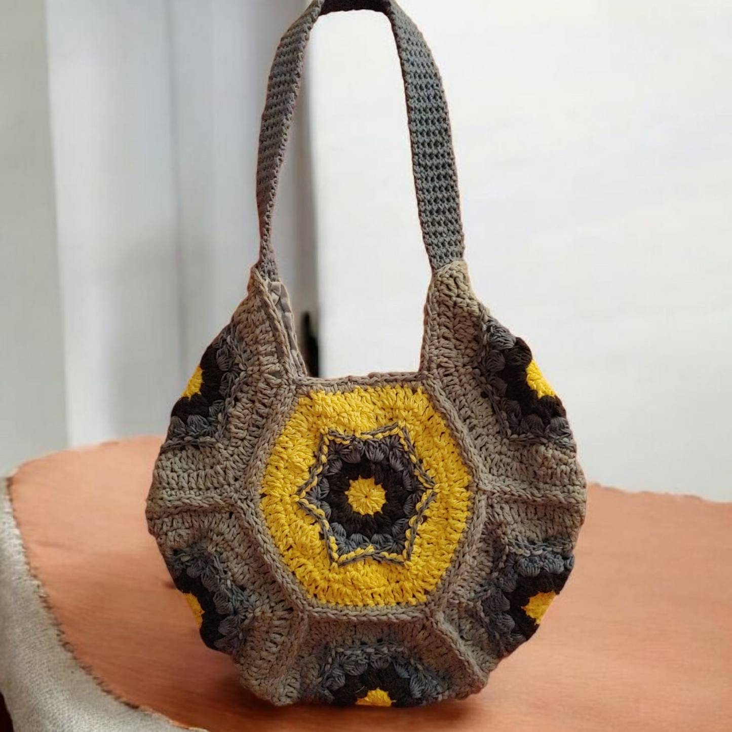 Crochet blue and yellow circular handbag.