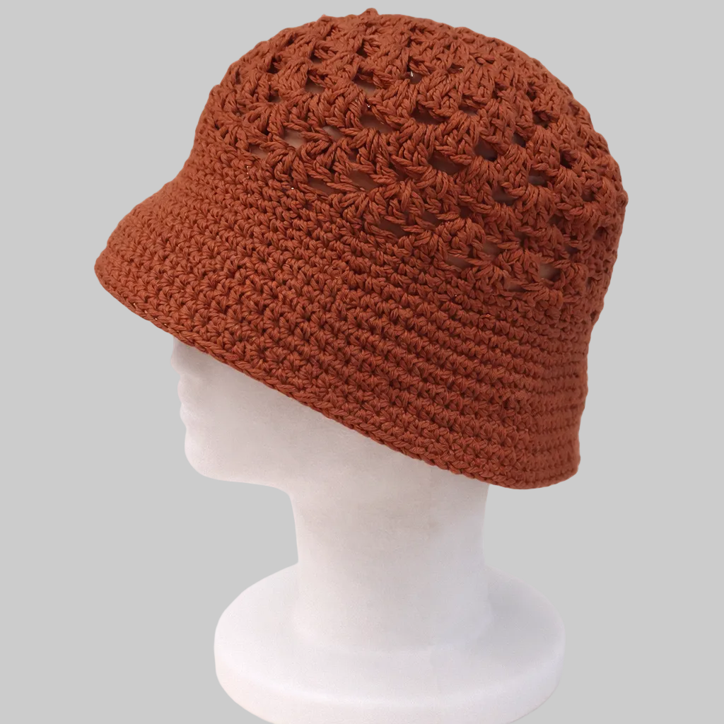 Handmade bronze crochet bucket hat crafted from eco-friendly cotton yarn, featuring a textured crown and soft structured brim.