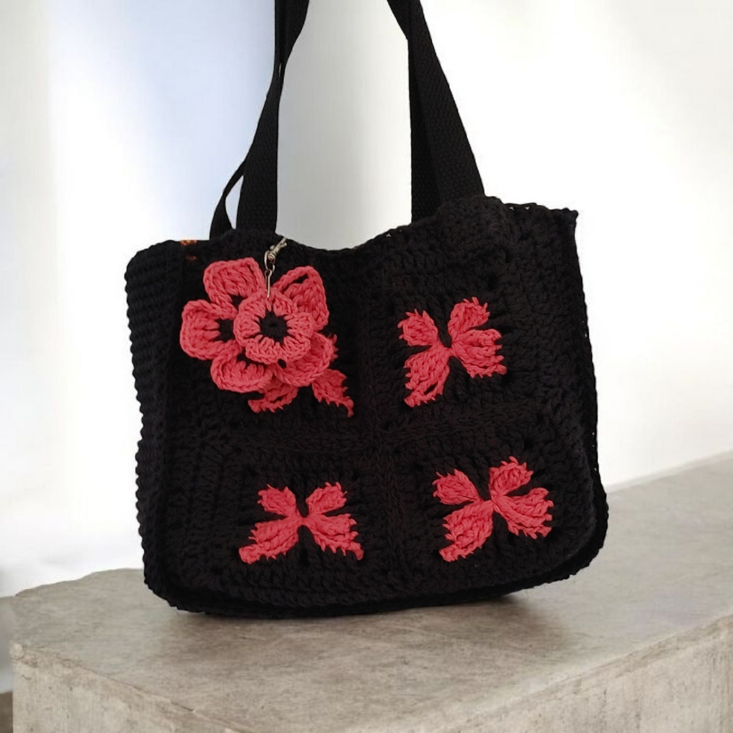Crochet black and coral butterfly handbag.