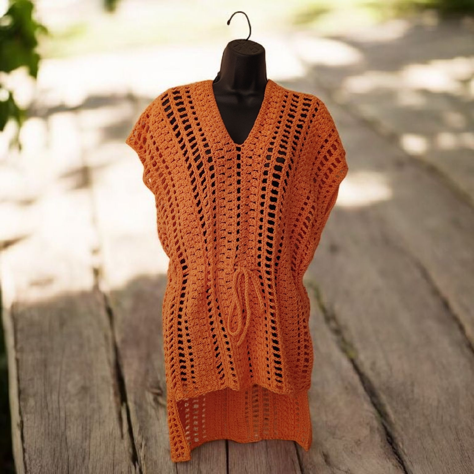 Crochet coral color beachwear with a drawstring waist.