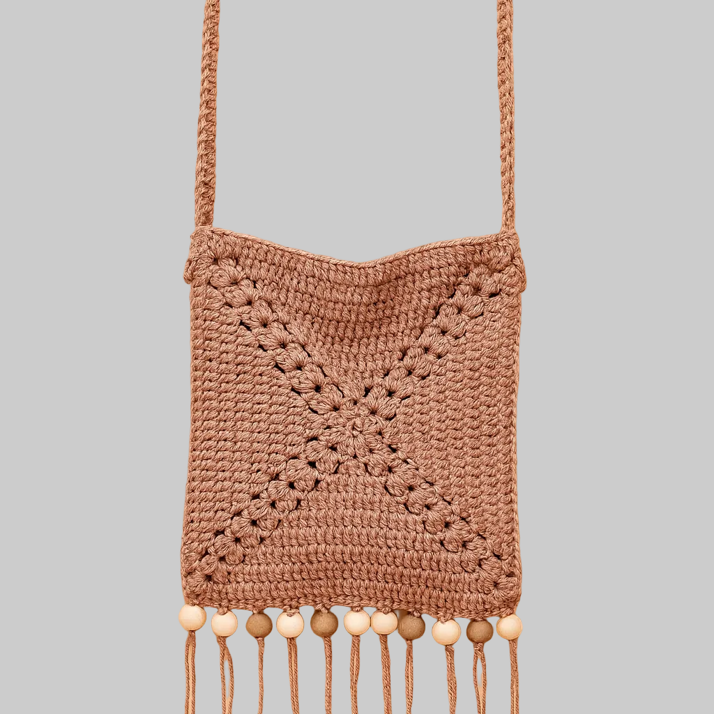 Handmade crochet granny square crossbody bag with fringe and wooden beads in earthy desert tones