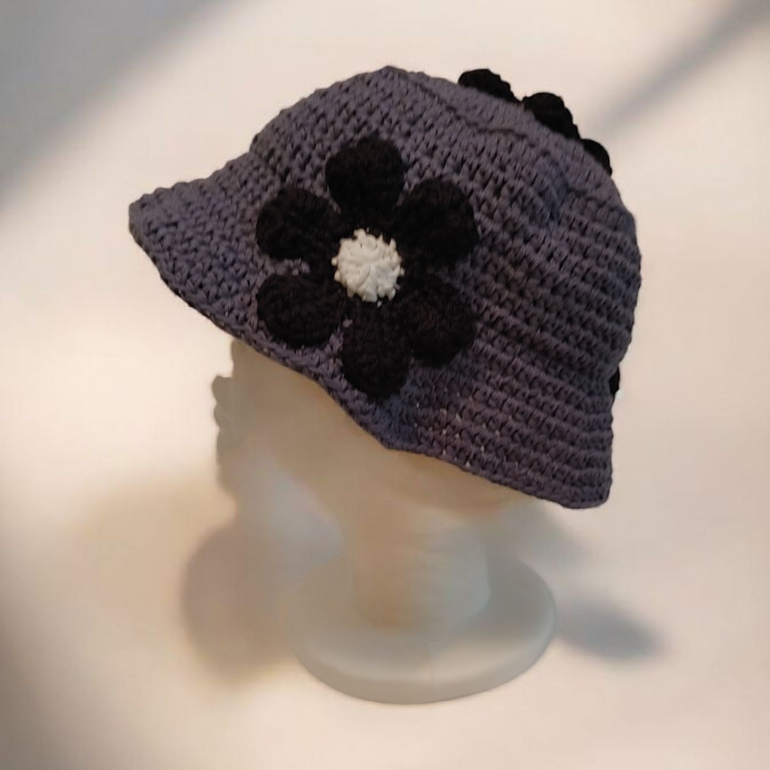 Grey and black floral crochet bucket hat.