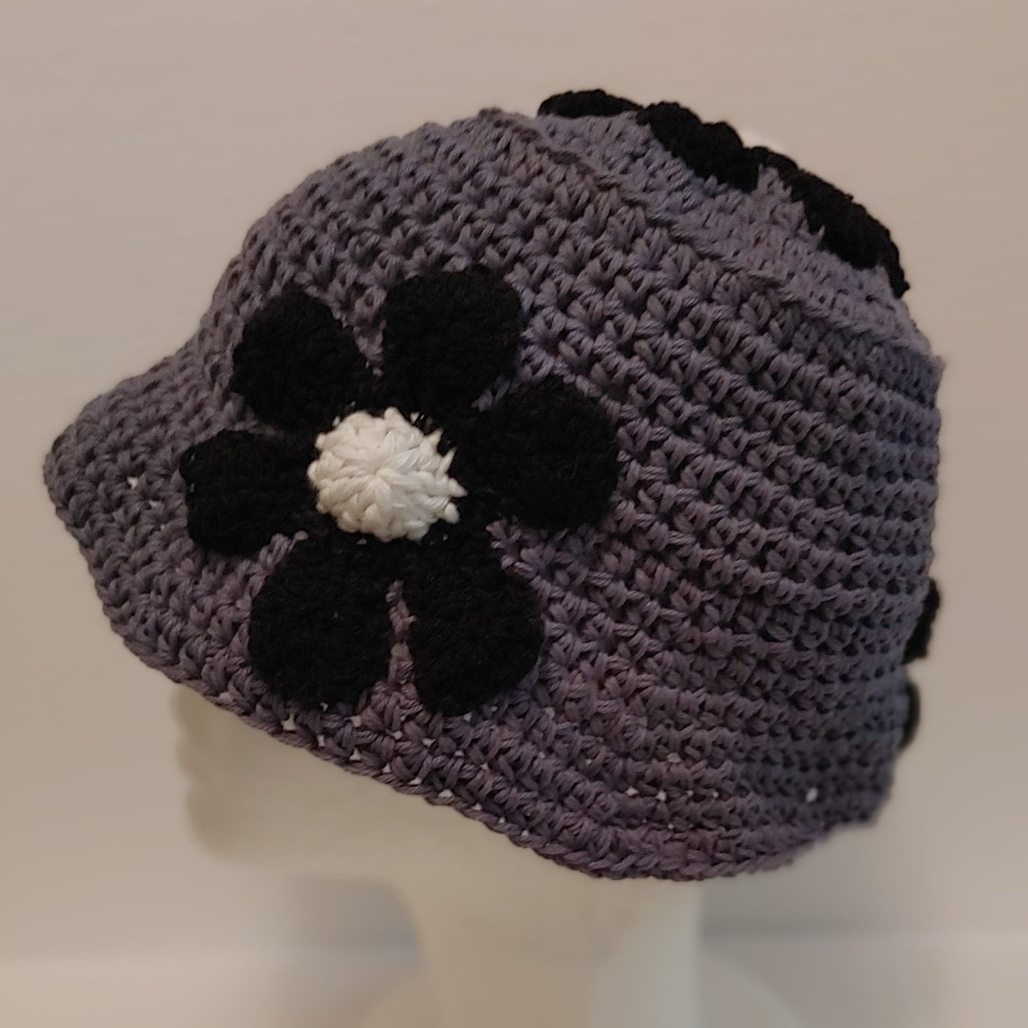 Grey and black floral crochet bucket hat.