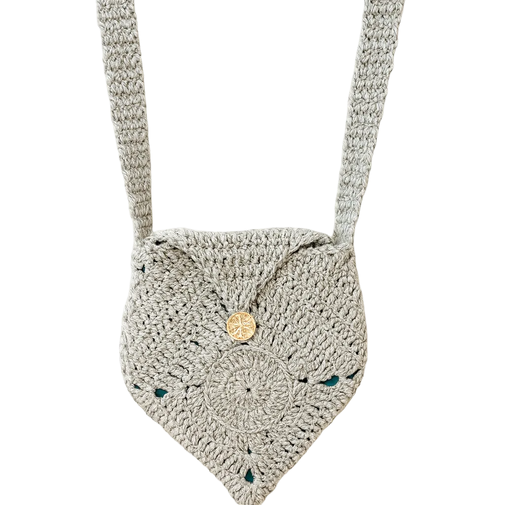 Handmade stone-colored crochet crossbody bag featuring a circular granny stitch flower design and button closure