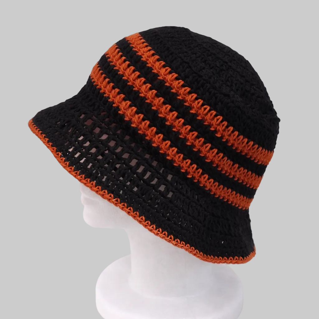 Handmade sunset coral crochet bucket hat with floral detailing, sustainable summer accessory by Green Stitch
